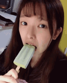 Pretty girl sucking popsicle while
