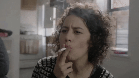 Girl smokes cigarette deeply inhaling